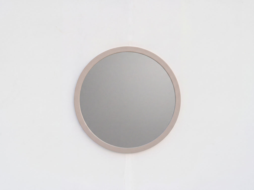 Arca 80 cm round wall mirror with wide taupe frame, styled in a modern interior