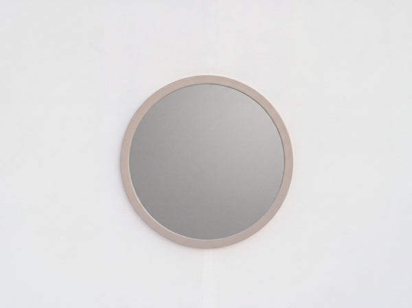 Arca 80 cm round wall mirror with wide taupe frame, styled in a modern interior
