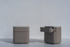 Pair of Arca taupe nightstands with stone tops against a white wall