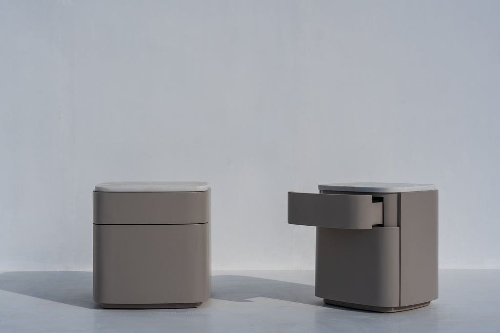 Pair of Arca taupe nightstands with stone tops against a white wall