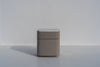 Arca rounded bedside table in taupe PU finish with engineered stone top, front view