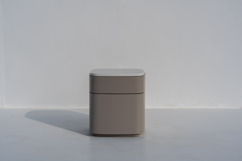 Arca rounded bedside table in taupe PU finish with engineered stone top, front view