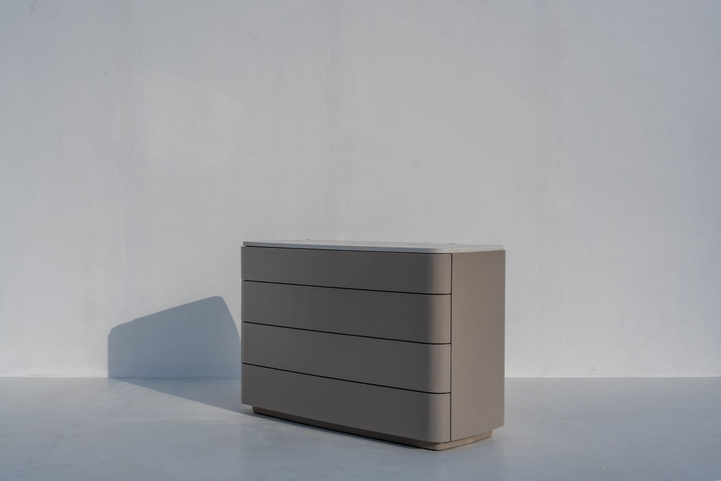 Arca four-drawer chest of drawers with curved wraparound fronts and engineered stone top