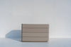 Arca four-drawer dresser in taupe PU finish, side view showing the rounded corners