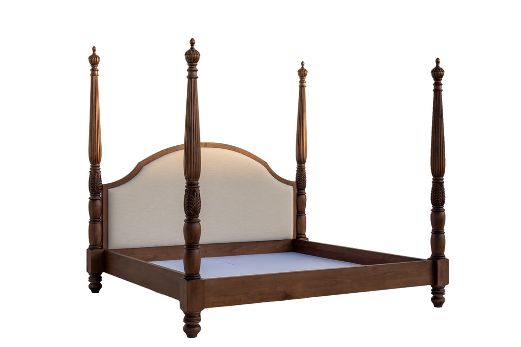 Three-quarter view of hand-carved solid wood four poster bed made to order in Dubai, on white