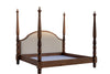 Carved four poster bed at an angle showing footboard post, side rail and linen headboard