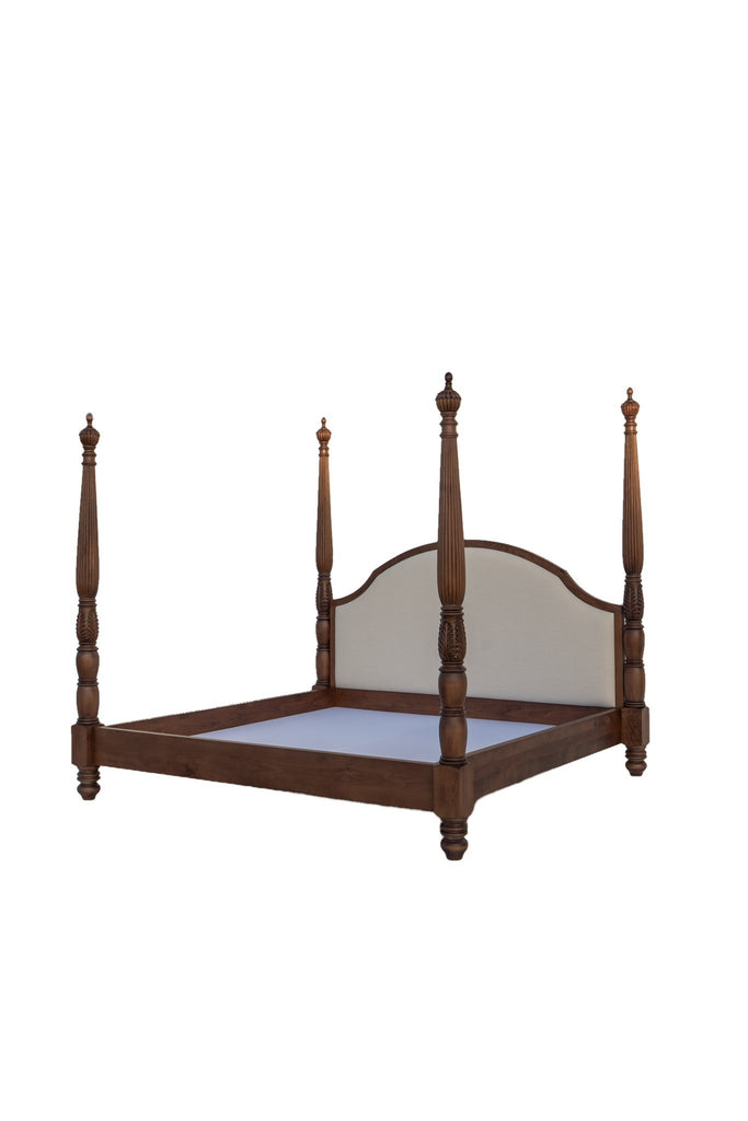Foot corner view of walnut four poster bed with solid wood side rails, on white