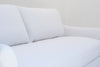 Detail of the Belmont loose back cushions and slope arm in white linen