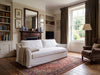 Belmont white linen slipcovered sofa in a classic living room with fireplace and rug