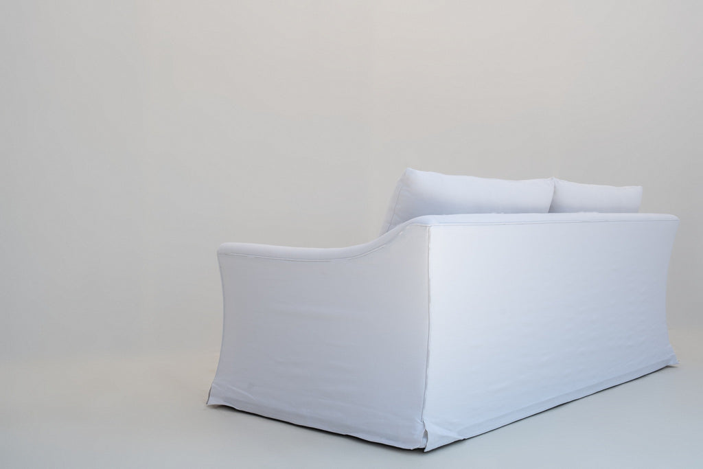 Rear three-quarter view of the Belmont linen sofa with flared arm and kick pleat