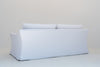 Belmont slipcovered sofa back view showing the tailored linen skirt