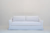 Slipcovered sofa in Dubai with a removable, washable white linen cover, front view
