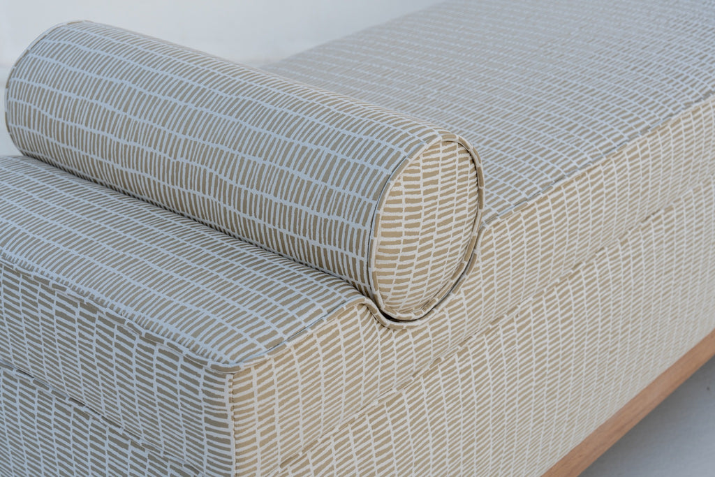Close-up of Carmel bench bolster cushion with self piping and dash-print upholstery