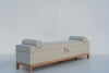 Carmel bolster storage bench three-quarter view, tailored upholstered bench on oak legs