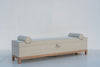 Oak storage bench with upholstered lift-up seat, fabric pull tab and two bolsters