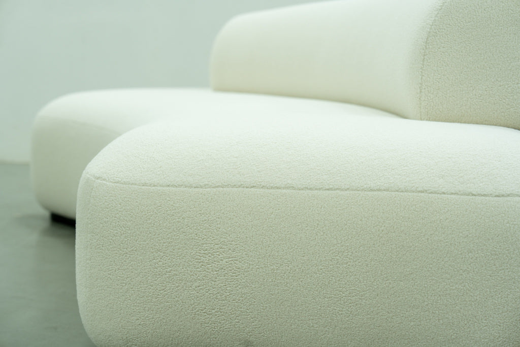 Close-up of the soft looped bouclé fabric on the Dune curved sofa