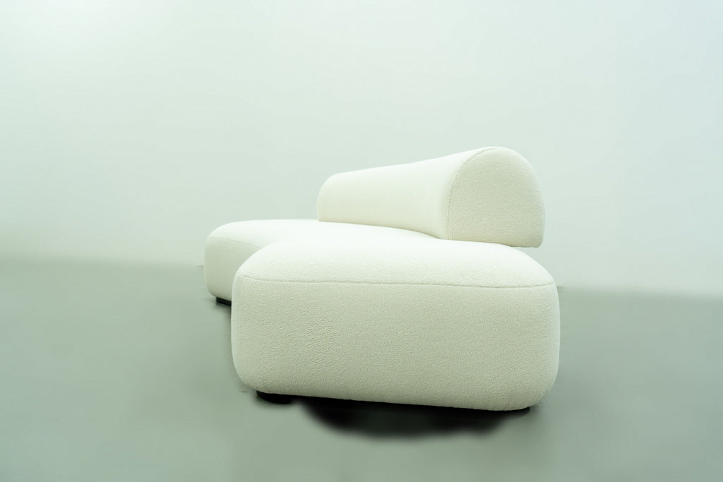 End view of the Dune curved sofa with rounded seat edges and bolster profile