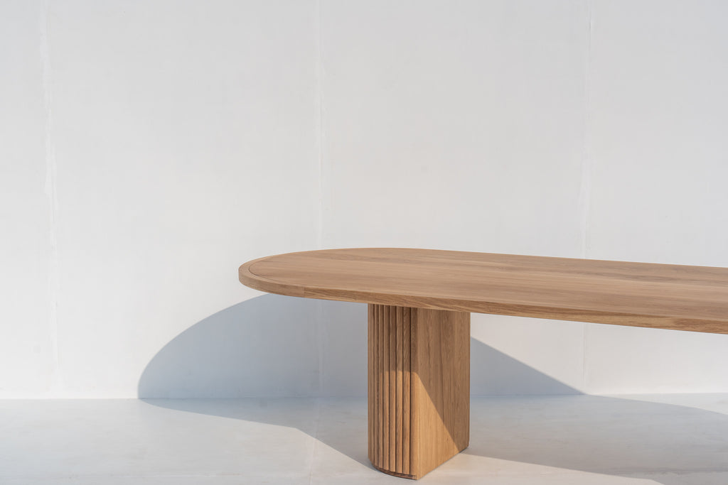 Calder solid oak oval dining table with fluted pedestal legs in Dubai