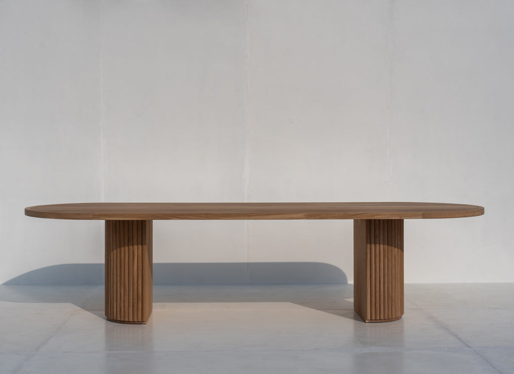 Calder Oak Dining Table in natural oak with two fluted pedestal legs