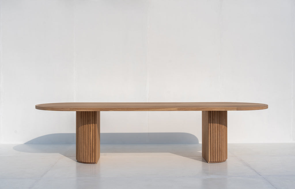 Calder Oak Dining Table in natural oak with two fluted pedestal legs