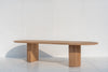Oval solid oak dining table with sculptural fluted oak pedestal base