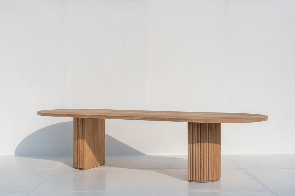 Oval solid oak dining table with sculptural fluted oak pedestal base