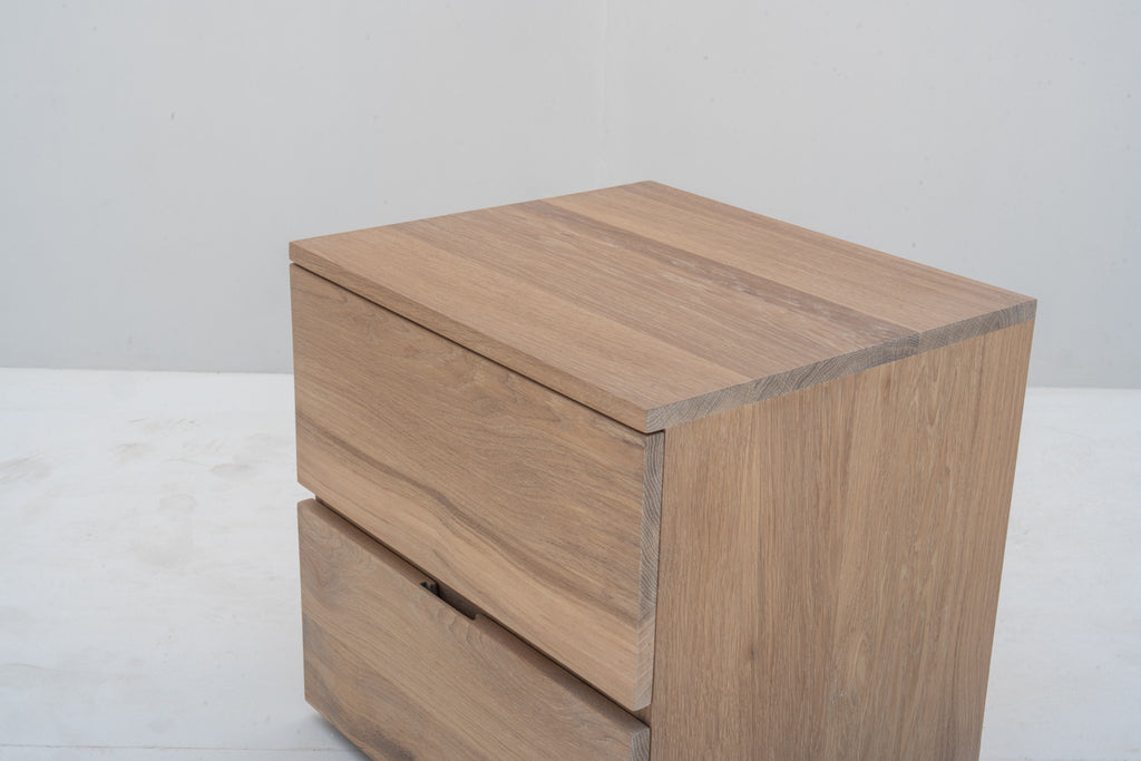 Minimalist natural oak bedside table with two handle-free drawers