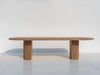 Oval solid oak dining table with sculptural fluted oak pedestal base