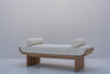 Solid oak upholstered bench featuring cylindrical bolster cushions