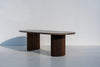 Livia Emperador marble oval dining table with fluted walnut base, three-quarter view