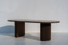 Livia marble and walnut dining table with rounded racetrack ends, angled view