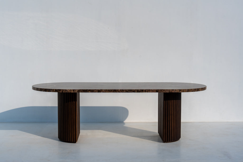 Livia luxury marble dining table with fluted walnut pedestals, end view