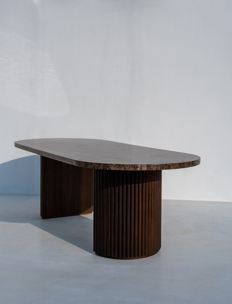 Livia oval marble dining table, Emperador Dark top on a fluted solid walnut pedestal base