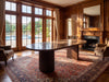 Livia dark marble table with walnut base in a wood-panelled room with a pool view