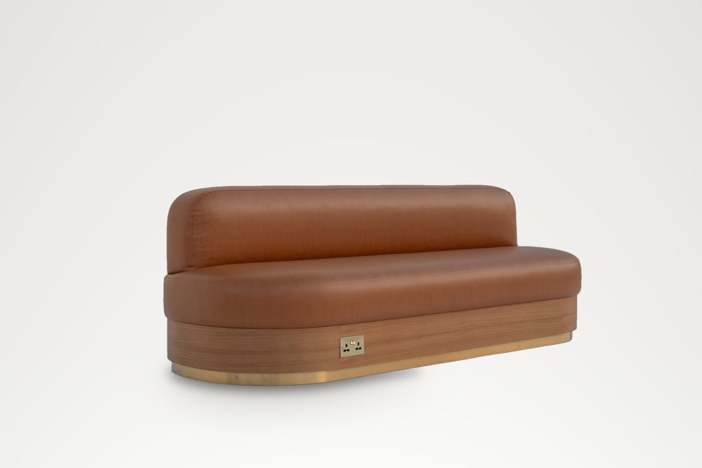 Marylebone leather banquette, angled view showing the rounded end and low upholstered back