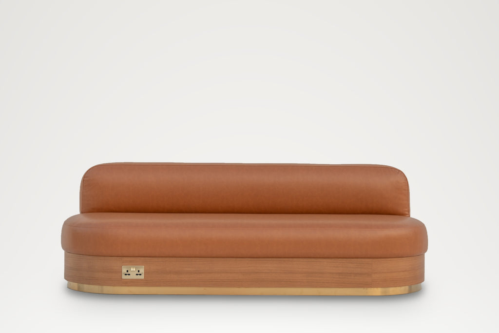 Leather banquette seating with wood-veneer plinth and brass socket, straight-on view