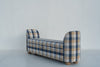 Upholstered storage bench with lift-up seat and fabric pull tab, side angle
