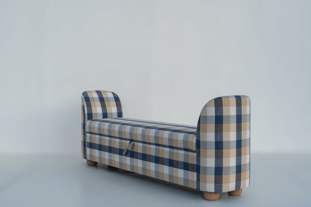 Upholstered storage bench with lift-up seat and fabric pull tab, side angle