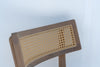 Close-up of the curved oak backrest with natural woven cane panel on the Ojai bar chair