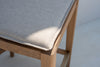 Close-up of the removable linen seat pad on the Ojai solid oak bar chair