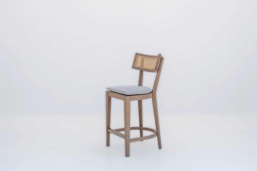 Ojai solid oak bar chair with oak footring and brushed brass kick plate, three-quarter view