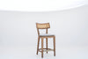 Ojai Oak & Cane Bar Chair in solid oak with natural cane back and linen seat pad, front view, made in Dubai