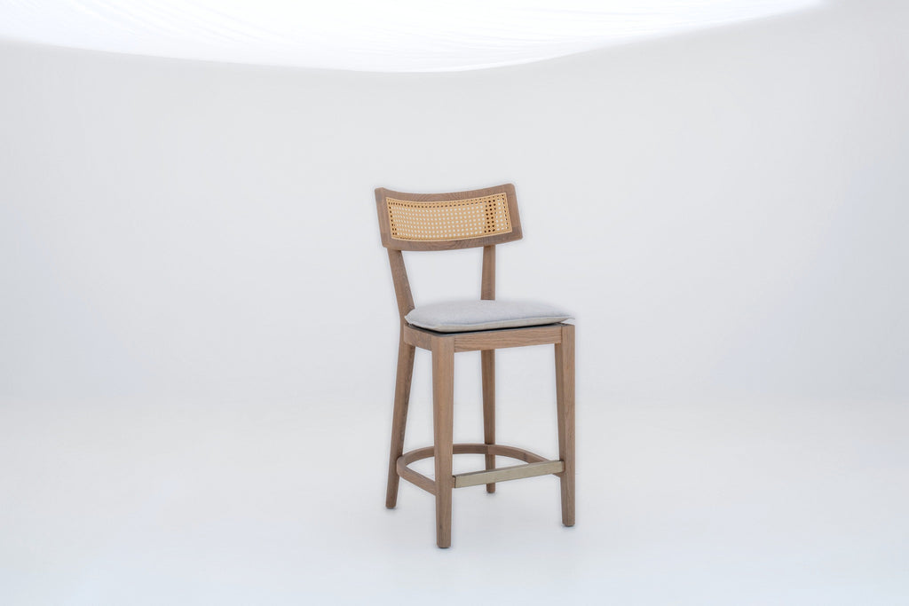Oak and cane counter stool with curved backrest and brass footrest, angled view
