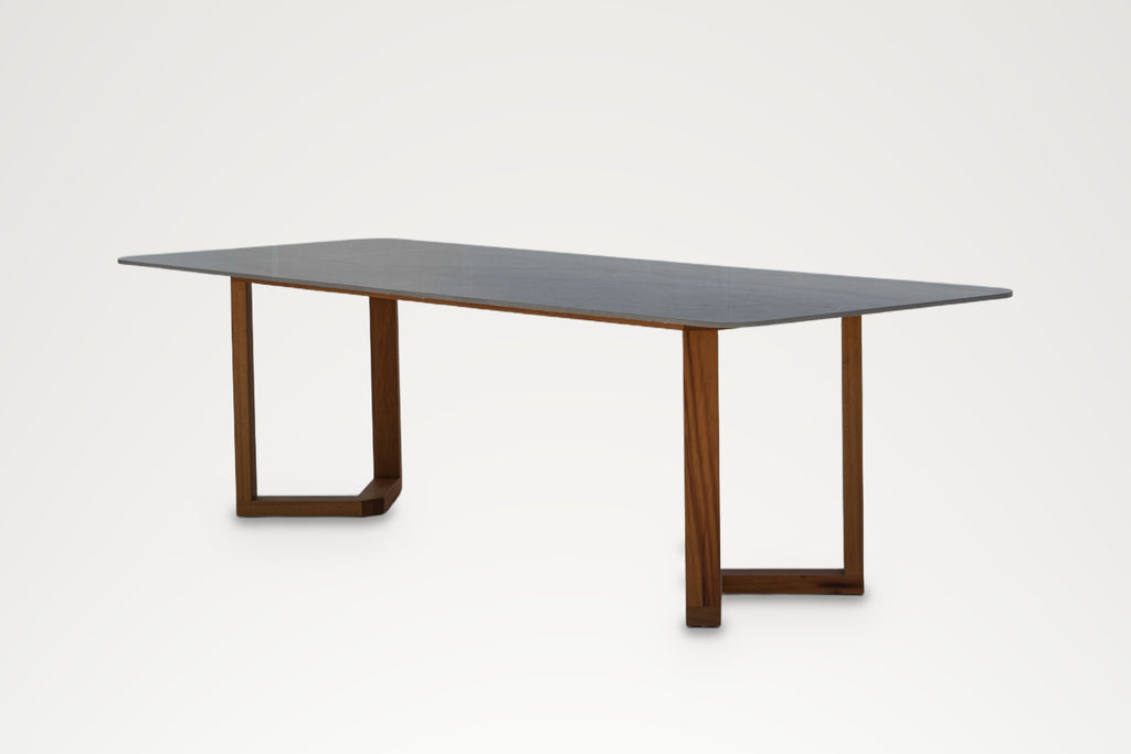 Pietra sintered stone dining table with solid teak legs made in Dubai, three-quarter view