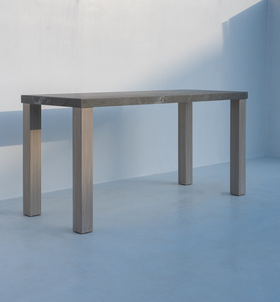 Pietra outdoor bar table with charcoal stone top and solid teak legs, 220 cm long, made in Dubai