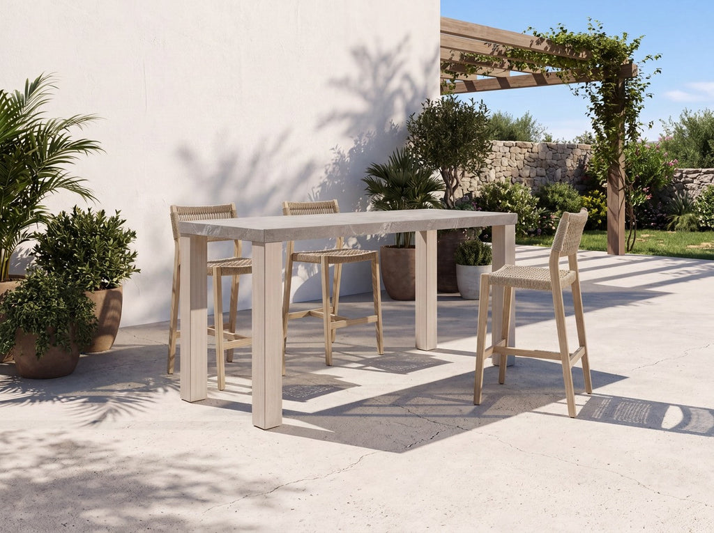 Pietra outdoor bar table with woven bar stools on a patio, a stone top teak bar table for Dubai terraces