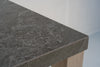 Close-up of the Pietra outdoor bar table charcoal stone top with natural light veining