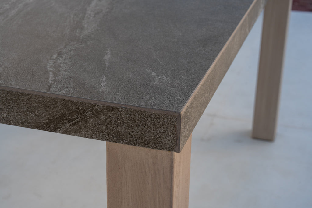 Pietra outdoor bar table stone top meeting a solid teak leg, joint detail