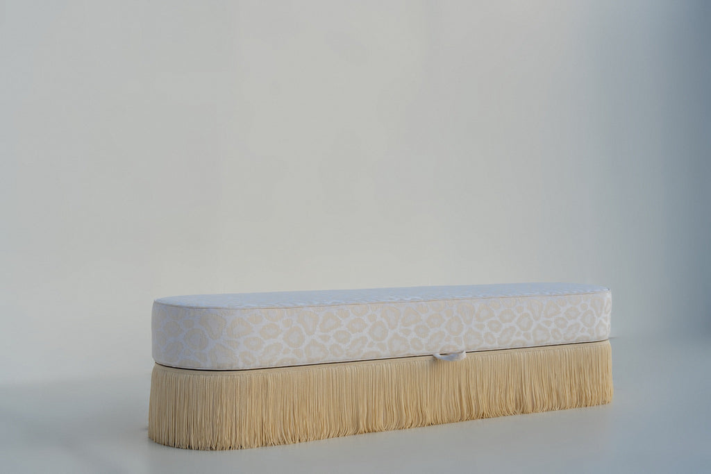 End of bed storage bench with cream bullion fringe, angled view, handmade in Dubai