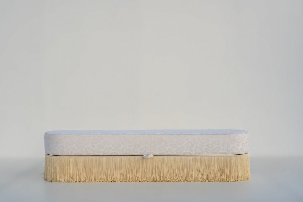 Savannah upholstered storage bench front view, ivory leopard jacquard with cream fringe skirt